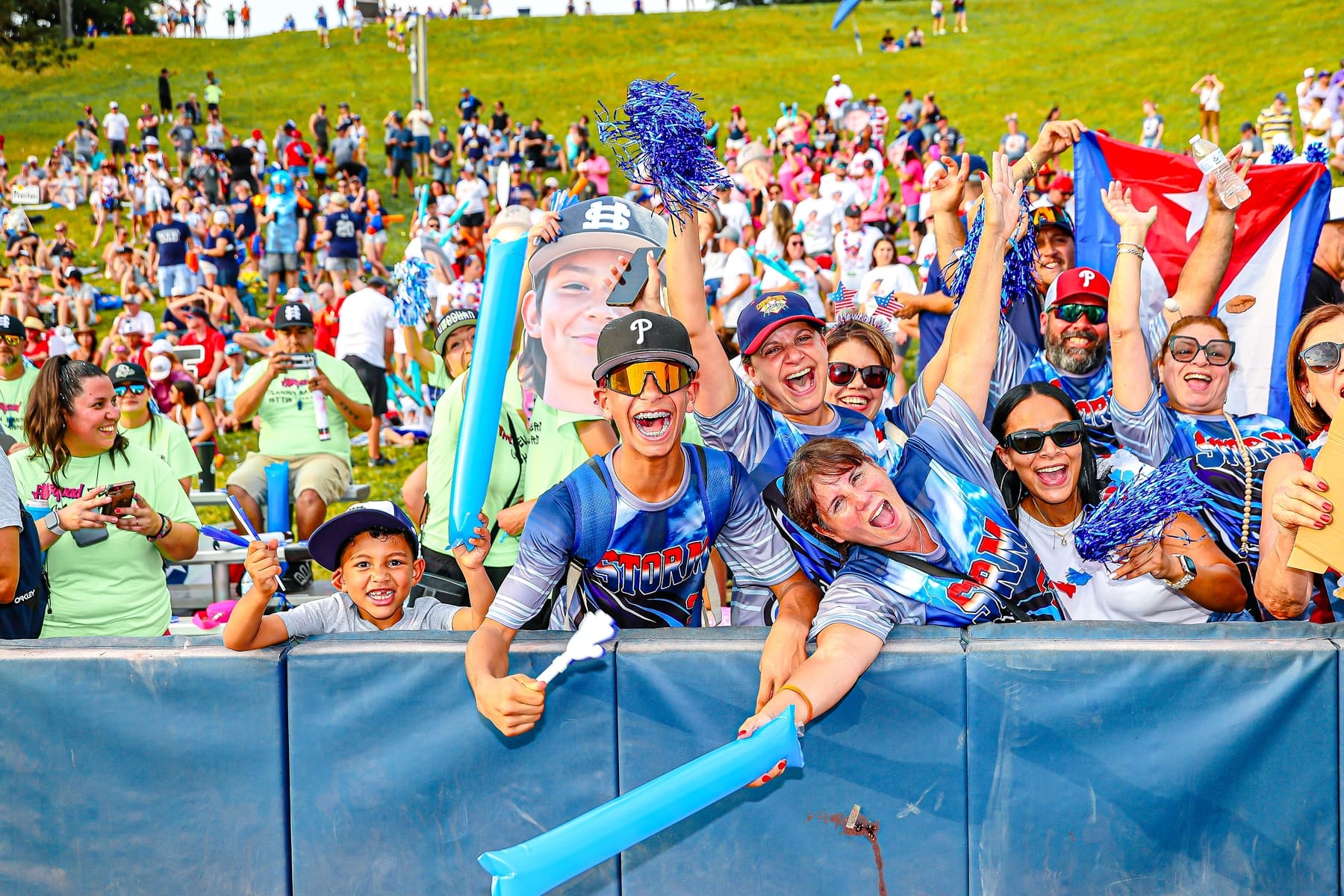 Cooperstown families cheering along the outfield fence