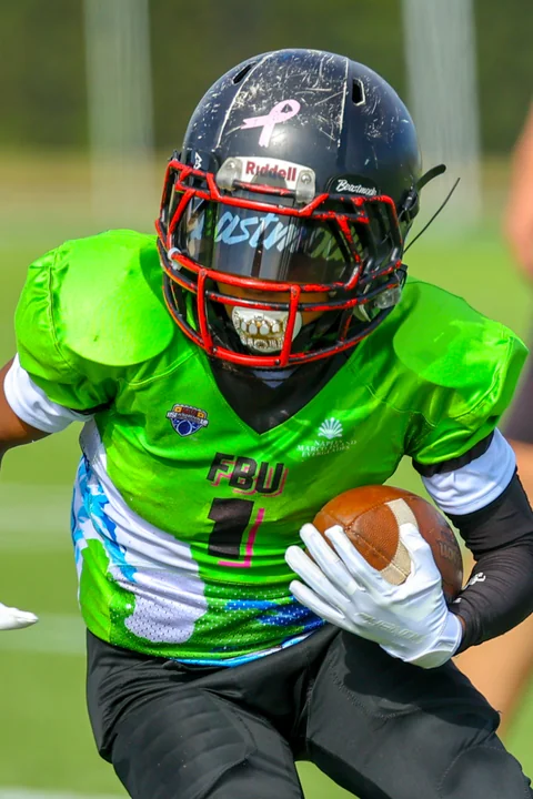 Running back in green cutting upfield