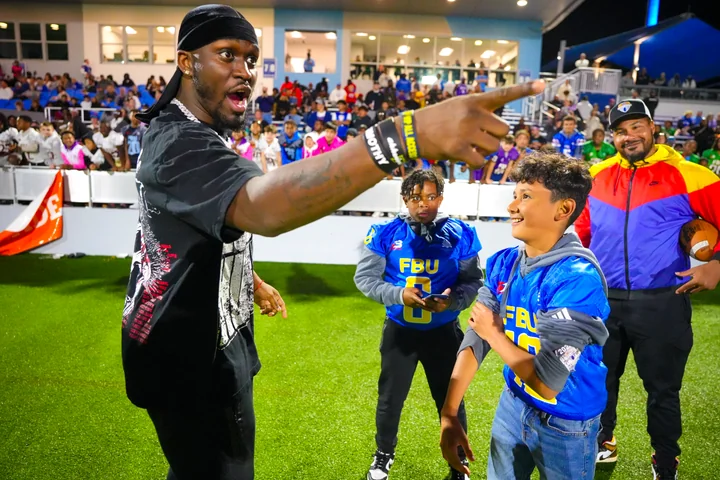 Guest coach pointing as players look on