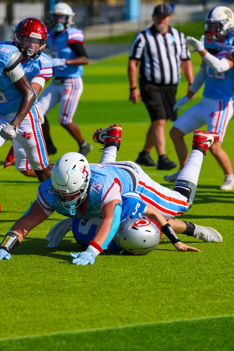 Lineman landing on the quarterback after a sack
