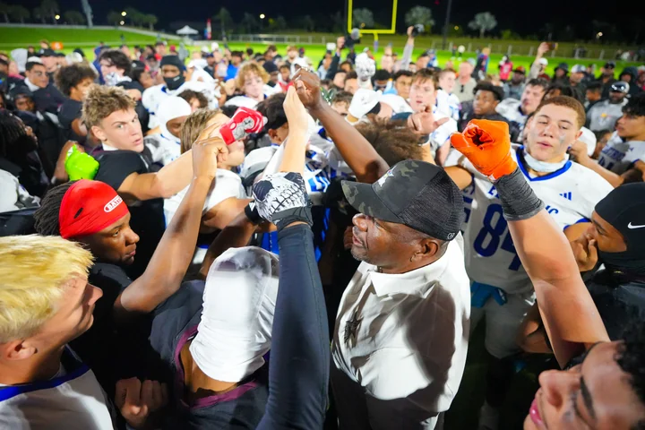 Coach and players gathered in a postgame huddle