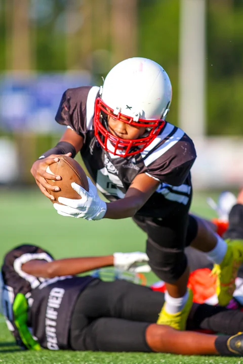Ball carrier diving forward with the ball