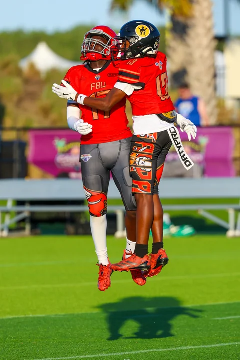Teammates in red jumping to celebrate