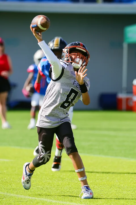 Quarterback in grey throwing a pass