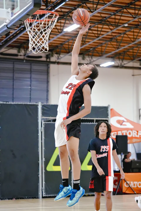 Player in white laying the ball up at the rim
