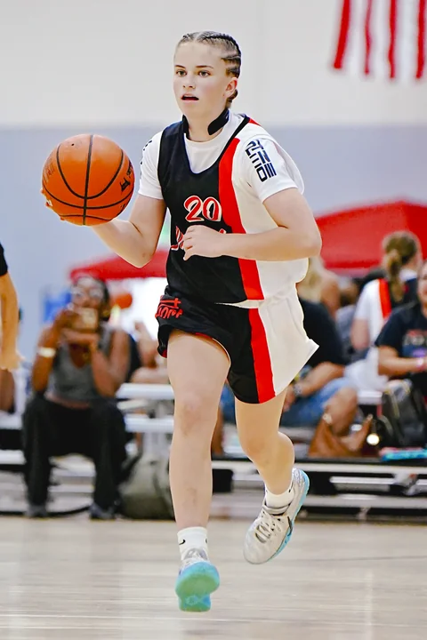 Guard in black bringing the ball up the court