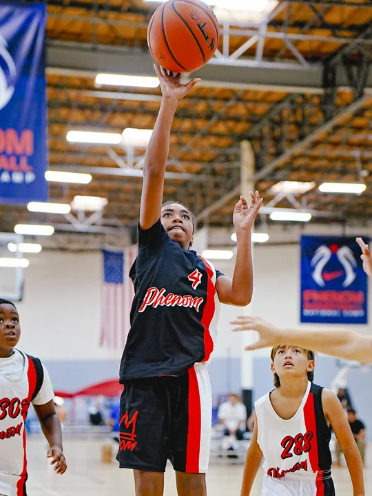 Player in black shooting a floater in the lane