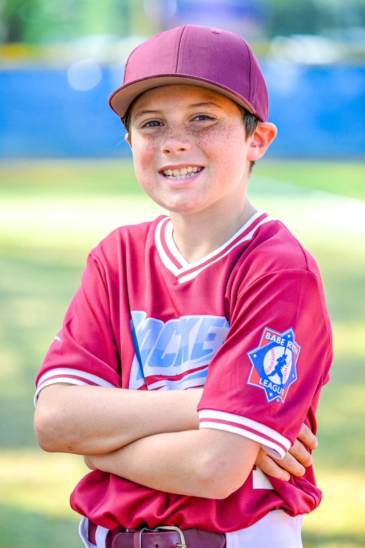 Smiling player in a red jersey with arms crossed